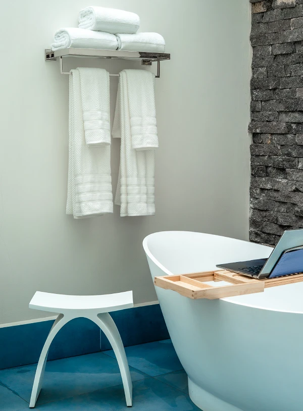 Full-Bathroom-with-Soaking-Tub Indulge in a private tropical oasis with a luxurious soaking tub and natural stone waterfall.
